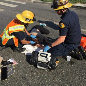 Rescue workers attending to the woman hit in crosswalk on Santa Monica Boulevard.